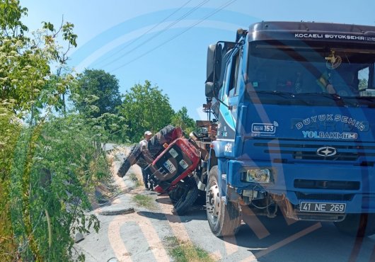 Freni boşalan kamyon  Traktörü altına aldı   